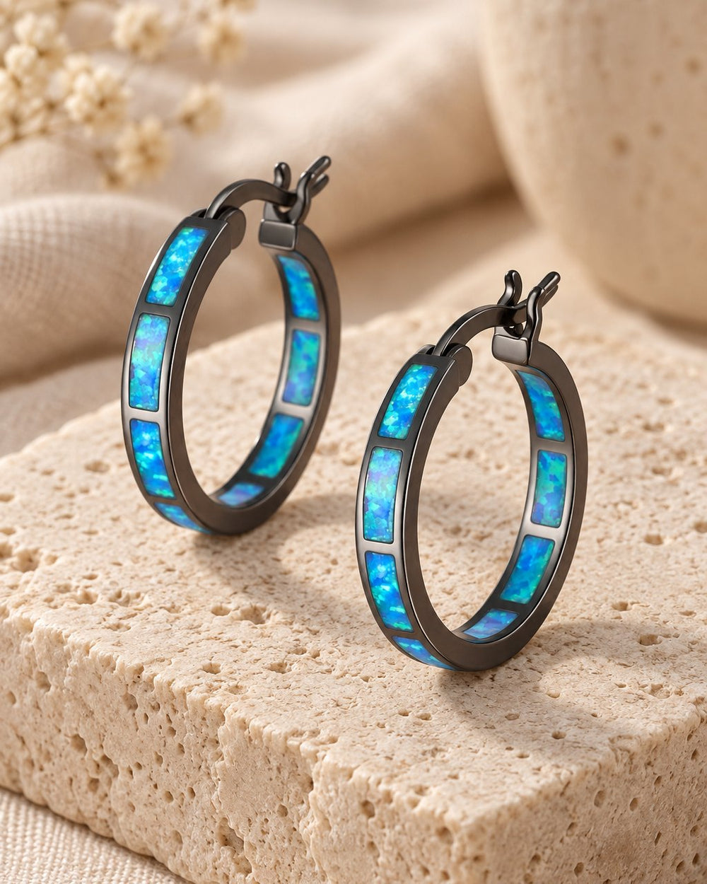 Pair of Blue Opal Hoop Earrings on a travertine block