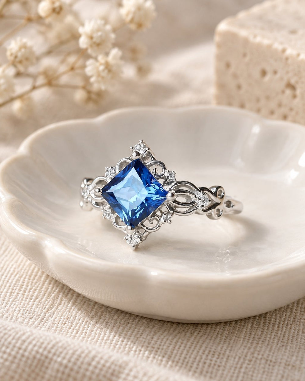 Princess Cut Lab Sapphire Ring in a small porcelain dish