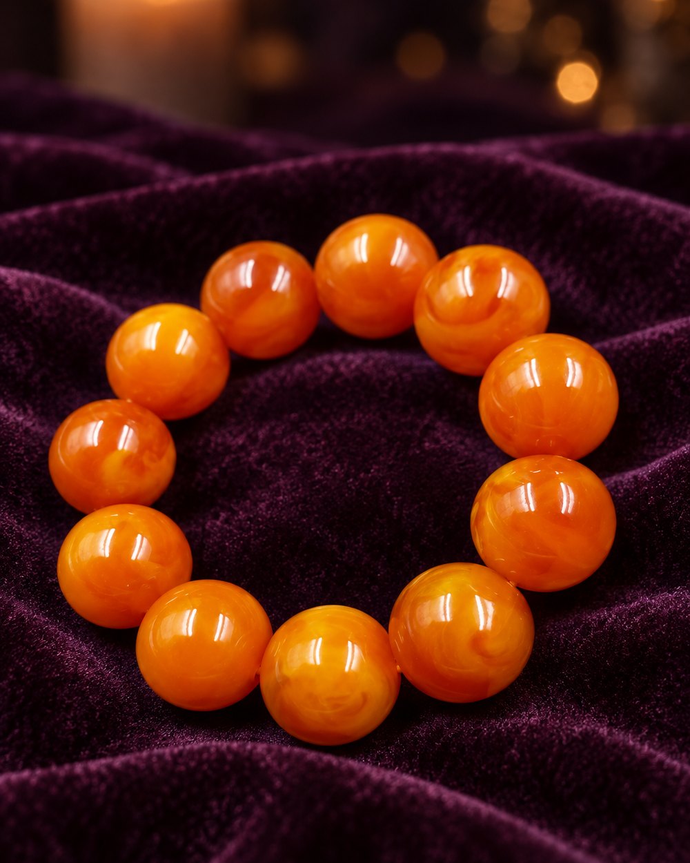 Big amber-tone bead stretch bracelet on plum velvet
