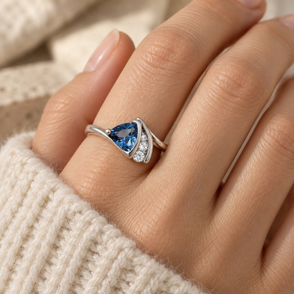 Blue Wave Triangle Ring worn on a woman's finger