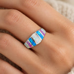 Blue & White Fire Opal Ring worn on a woman's finger