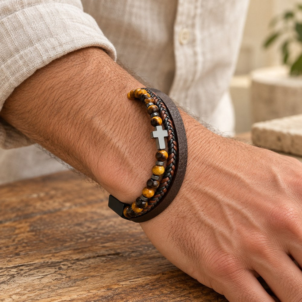 Layered leather bracelet with a cross and tiger eye beads on a man's wrist