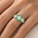 Green Fire Opal & Emerald Ring worn on a woman's finger