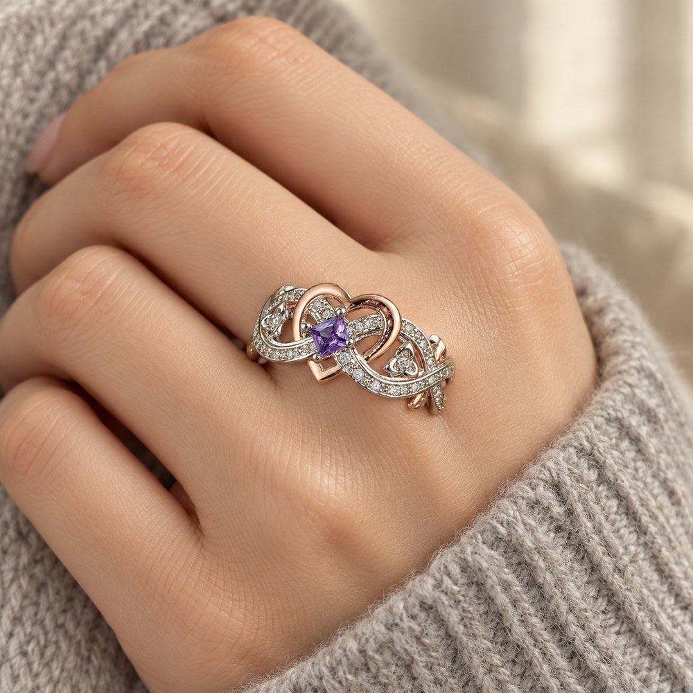 Two-Tone Heart & Rose Ring with a purple stone, worn on a woman's finger
