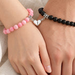Pink and black magnetic couples bracelets with the heart halves joined