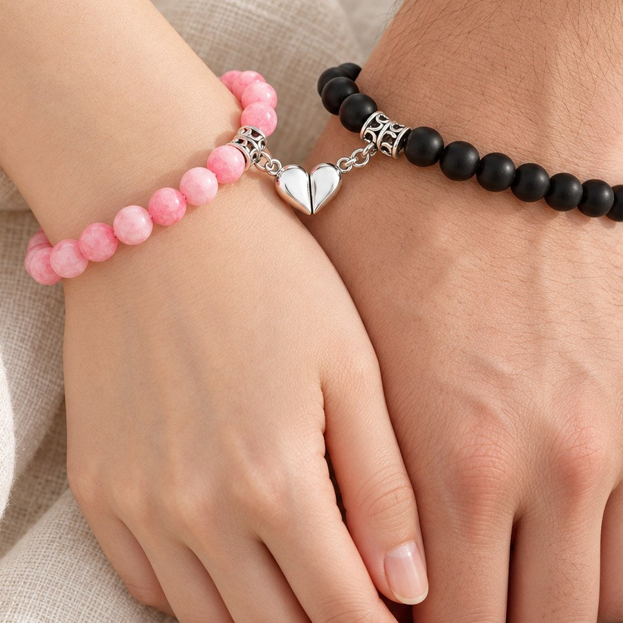 Pink and black magnetic couples bracelets with the heart halves joined