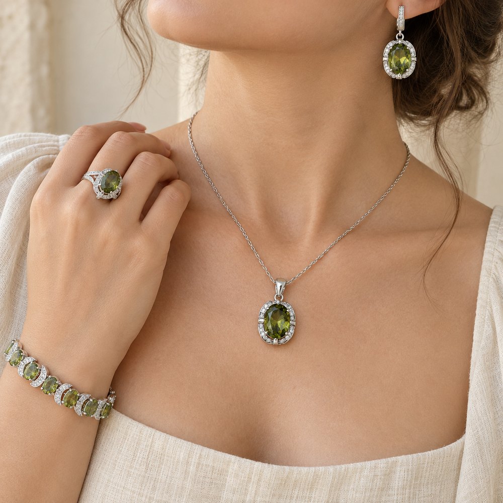 Green oval halo jewelry set worn: pendant necklace, drop earring, ring and bracelet