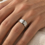 8 mm brushed stainless steel band worn on a man's ring finger