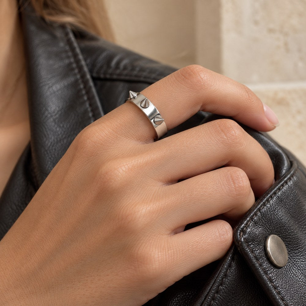 Silver stainless steel spike ring worn on a woman's finger