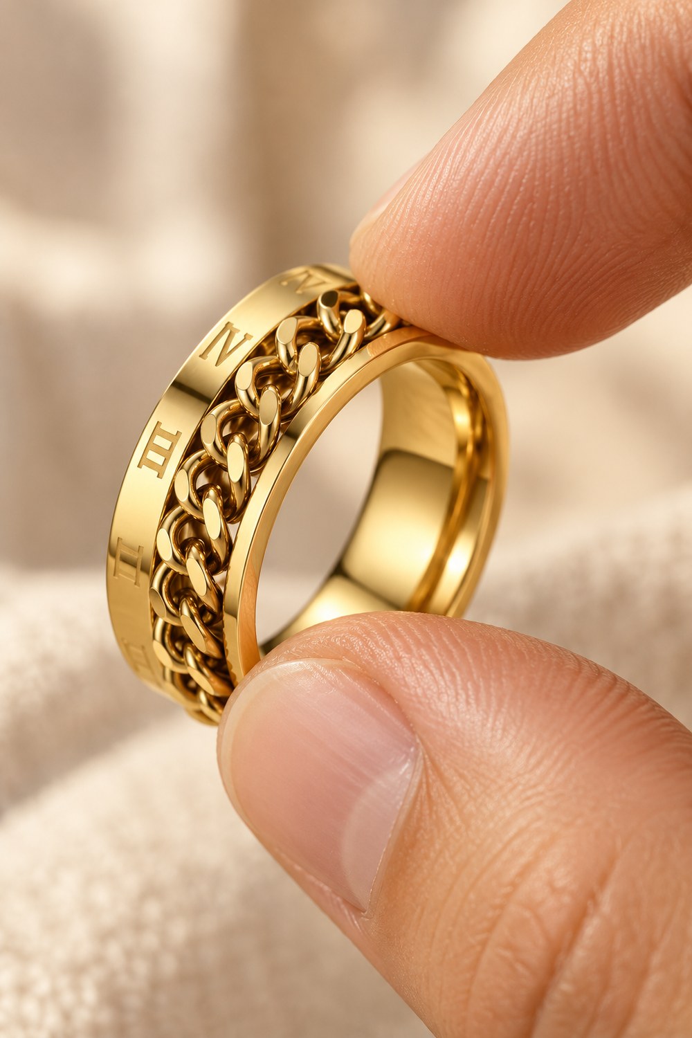 Turning the center chain of the Roman Numeral Spinner Ring between thumb and finger