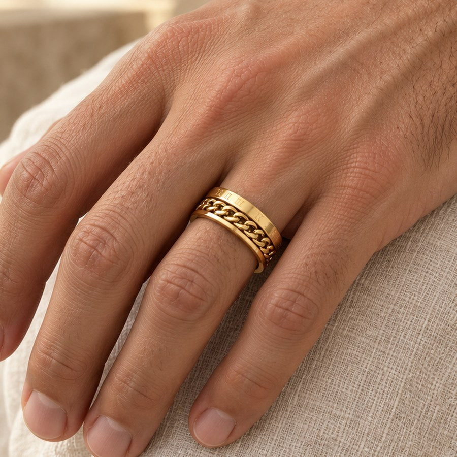 Roman Numeral Spinner Ring in gold-tone, worn on a man's ring finger