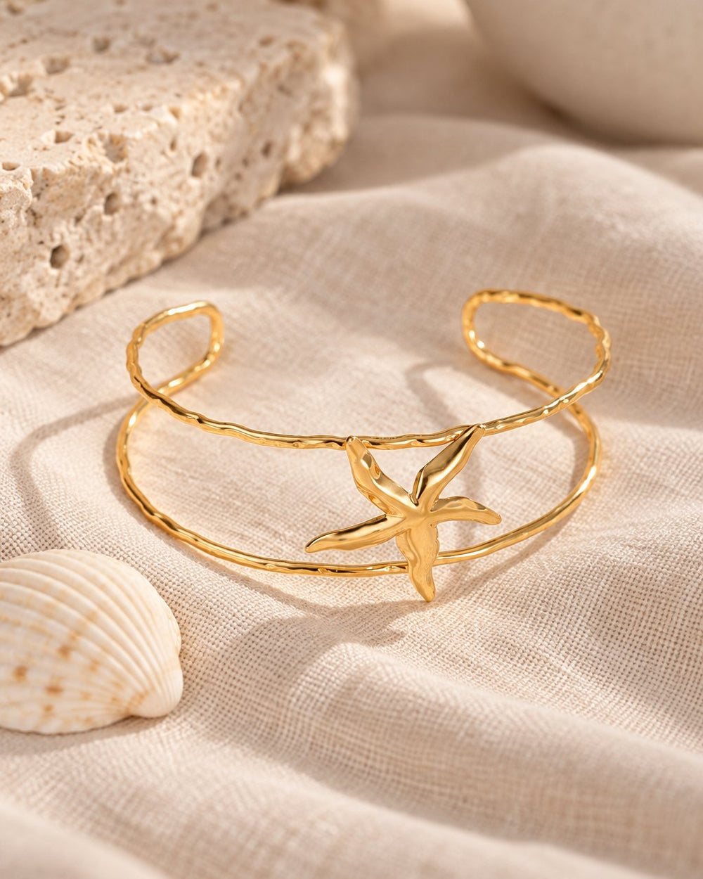 Starfish Double-Layer Cuff on linen beside a seashell