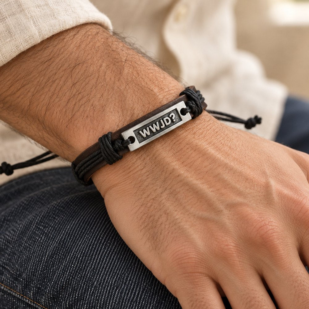WWJD leather cuff bracelet worn on a man's wrist