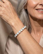 Elegant woman wearing the White Fire Opal Bracelet - AtPerry's